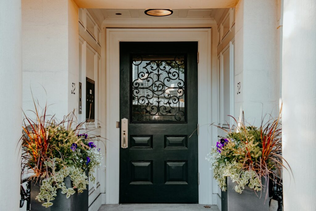 Black front door with planters