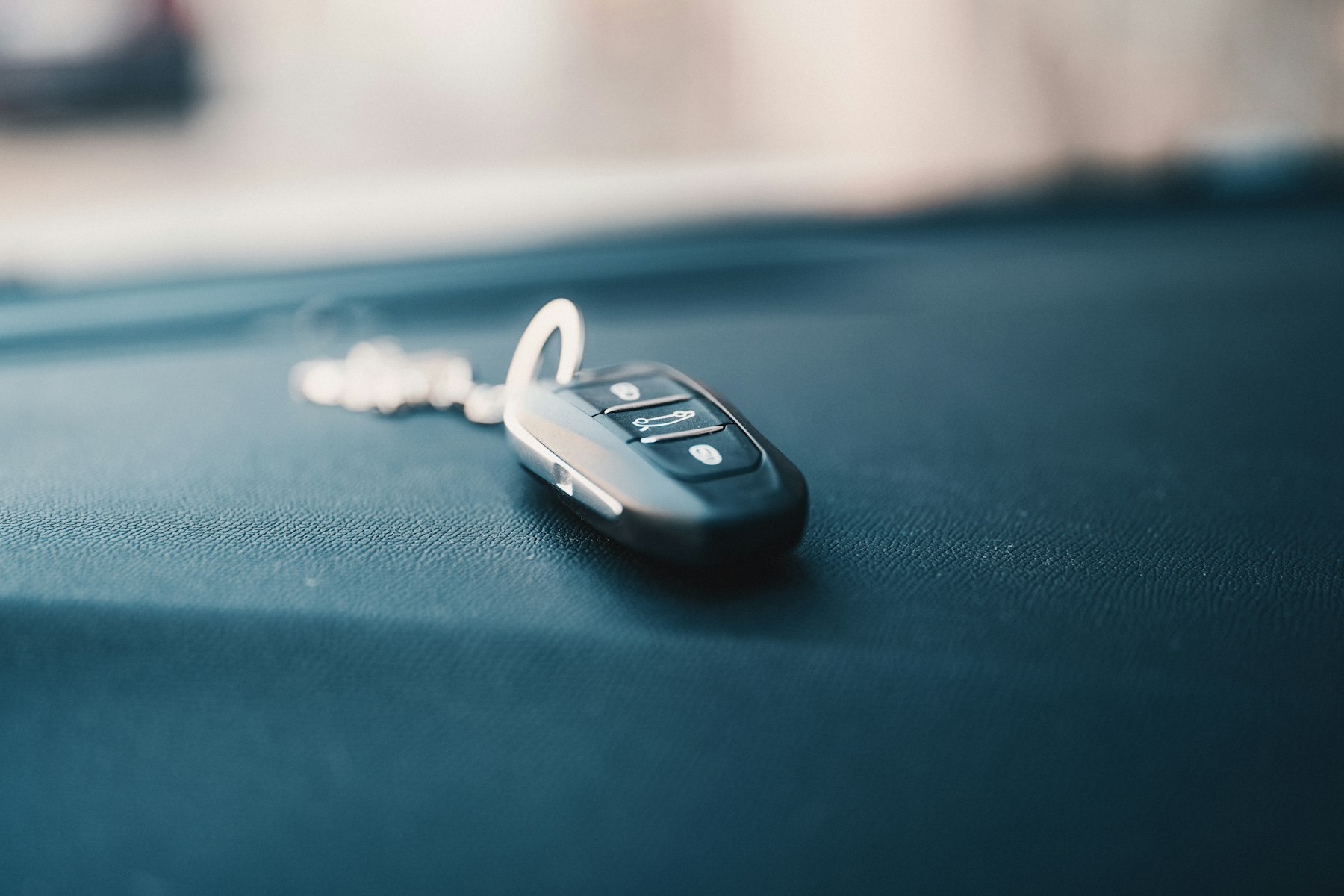 Car key fob resting on a dashboard