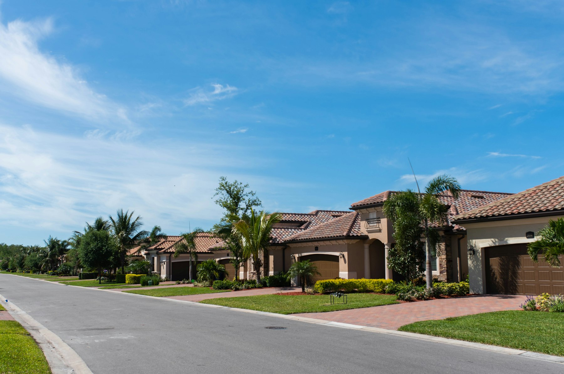 Quiet Florida street lined with tile roof homes